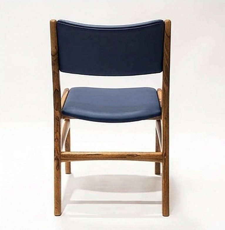 Silla AALTO en madera maciza de nogal cafetero tapizada en cuero sintético azul oscuro, vista trasera, hecha a mano por Canorá en Bogotá